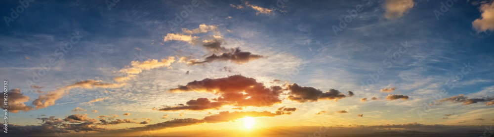 Obraz premium A beautiful sunset sky with yellow and orange colours as a background or texture