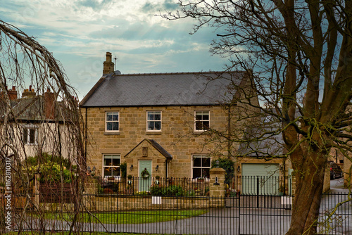 Two-Story Stone House with Detached Garage and Fence in Knaresborough, UK.