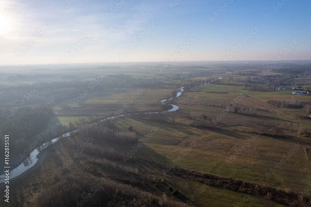 View of the Świder River (nature reserve) from a drone, aerial photo, winter, day, cloudless sky