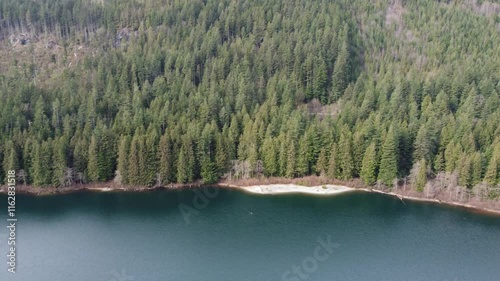 Wallpaper Mural Moody day in nature: flying over a tranquil lake and forested mountains Torontodigital.ca
