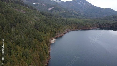Wallpaper Mural Floating above a calm lake with cloudy skies and lush forested peaks Torontodigital.ca