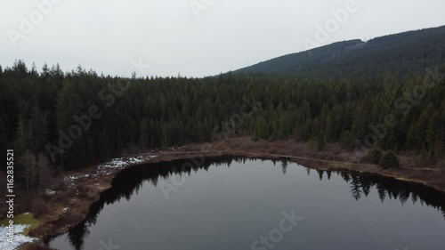 Wallpaper Mural Nature’s calm revealed: flying over a lake and mountains on a cloudy day Torontodigital.ca