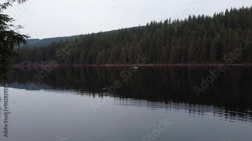 Wallpaper Mural Flying over a quiet lake surrounded by green mountains on an overcast day Torontodigital.ca
