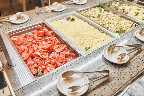 Fresh tomatoes and mimosa salad, traditional dishes in metal containers, a buffet with Russian dishes. With space to copy. High quality photo photo