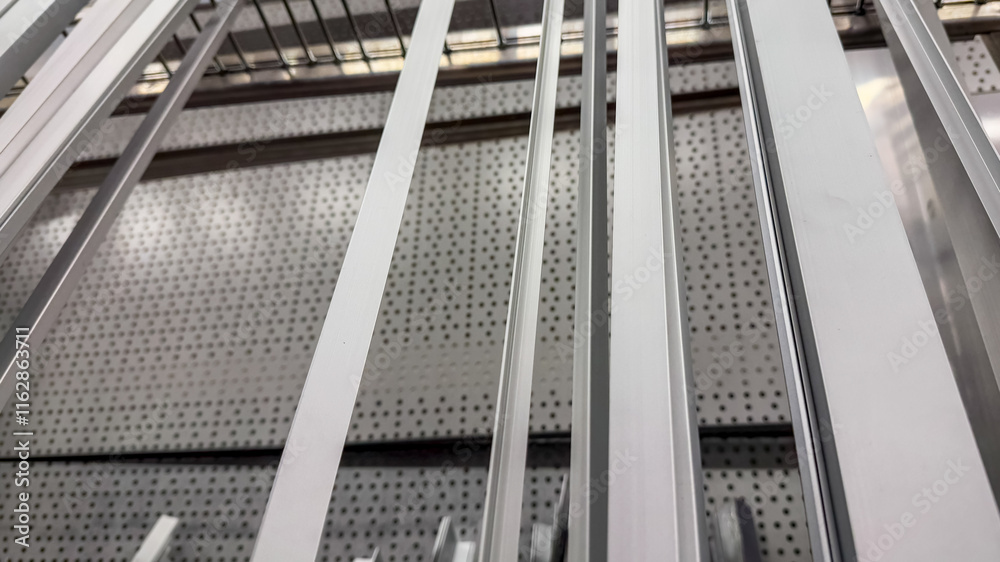 Fototapeta premium Close-up view of metallic shelves in a warehouse, illustrating industrial organization and storage efficiency