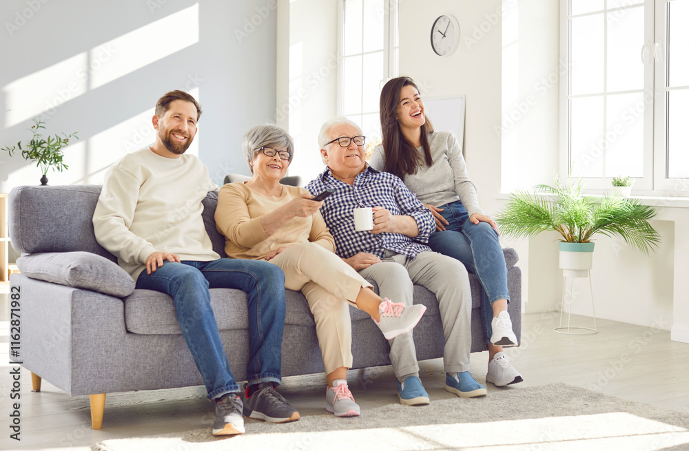 Happy family at home, senior old parents and adult children sitting on sofa together, laughing, enjoying tv watching common meeting, leisure, good relationship, generation unity in care united Happy family at home, senior old parents and adult children sitting on sofa together, laughing, enjoying tv watching common meeting, leisure, good relationship, generation unity in care united