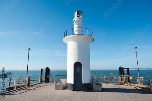 lighthouse in a Jetty. Pier in the Alcochete village in Portugal photo