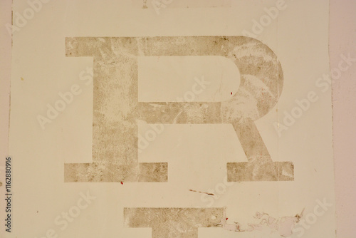 letter R deleted on pale yellow ochre photo