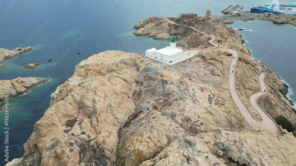 Vue aérienne professionnel panoramique au drone de L'Île-Rousse, de la Pietra, en Corse avec phare en bord de mer méditerranée, France