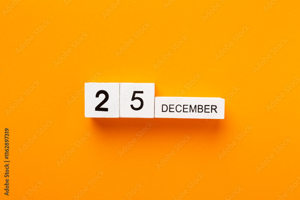 Calendar with date December 25 on color background, top view Calendar with date December 25 on color background, top view