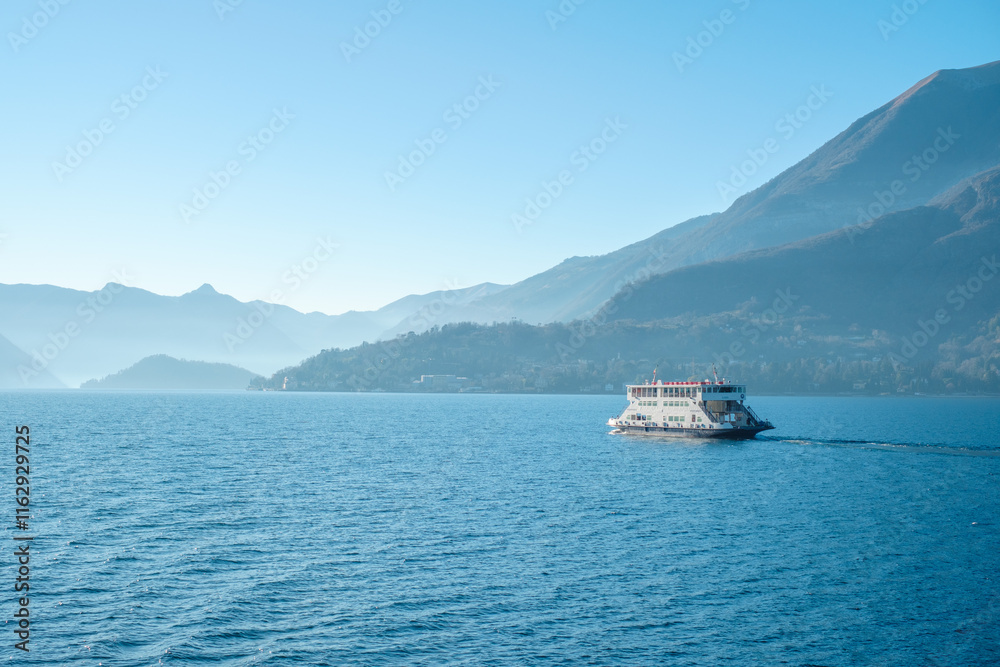 A Ferry Crossing Lake Como with Scenic Mountain Backdrop A Ferry Crossing Lake Como with Scenic Mountain Backdrop