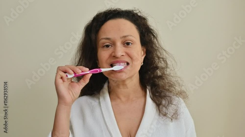 Woman Brushing Teeth Promoting Dental Hygiene in Bright Indoor Setting