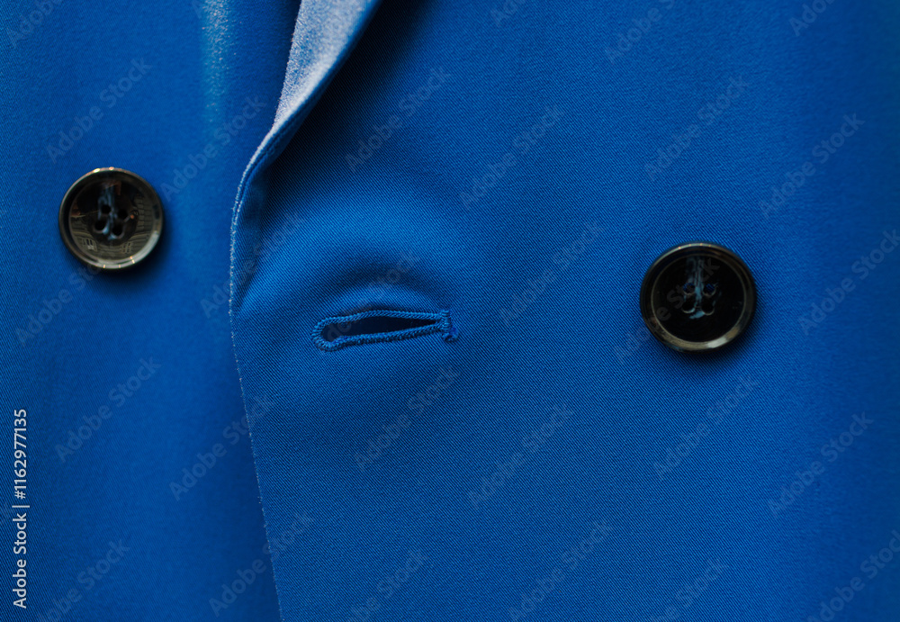 Buttons on the sleeve of a blue men's suit Buttons on the sleeve of a blue men's suit