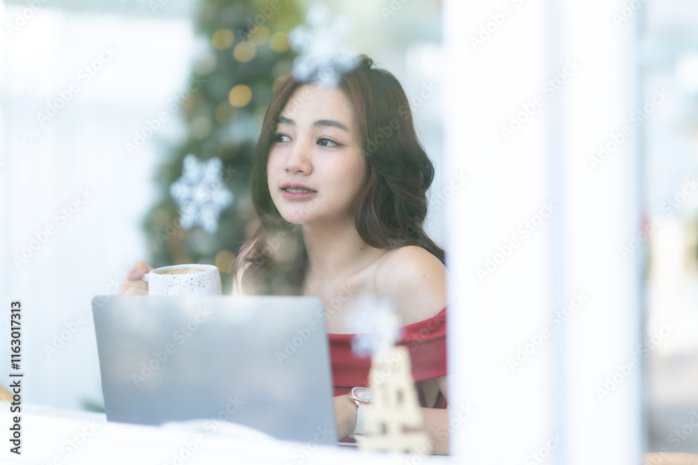 asian freelance people business female talking making using casual working with laptop computer and coffee at home in the living room indoors Decoration During Christmas x-mas and New Year holidays.