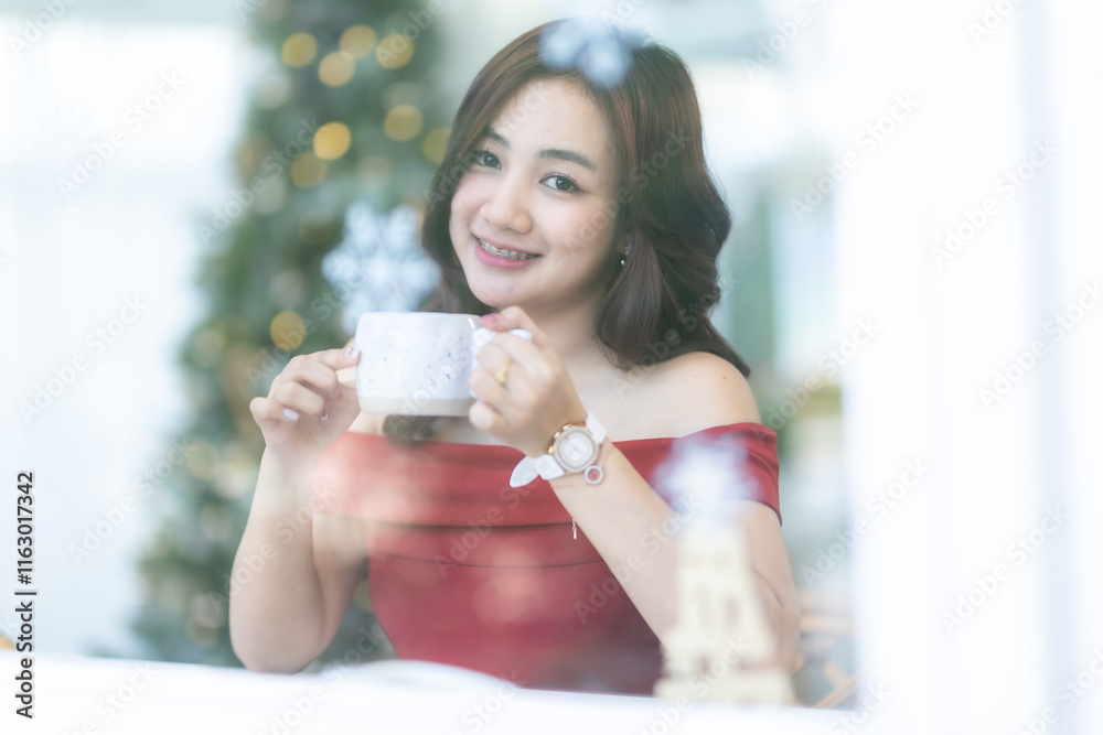 beautiful asian woman relaxing In a red dress holding of positive the having cup of coffee or chocolate at home in the living room indoors Decoration During Christmas x-mas and New Year holiday. beautiful asian woman relaxing In a red dress holding of positive the having cup of coffee or chocolate at home in the living room indoors Decoration During Christmas x-mas and New Year holiday.
