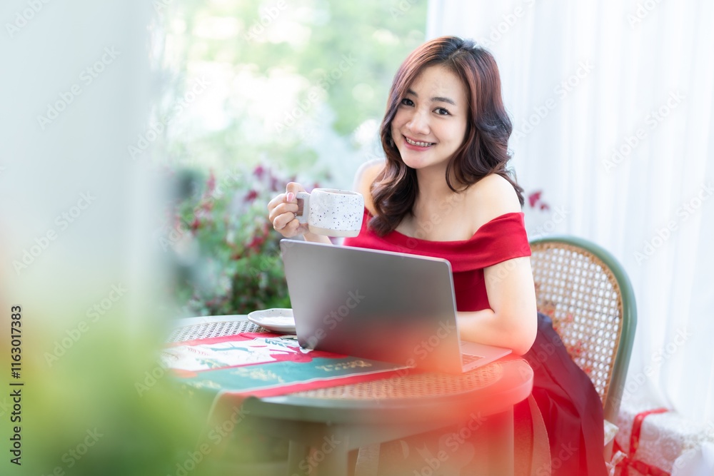 asian freelance people business female talking making using casual working with laptop computer and coffee at home in the living room indoors Decoration During Christmas x-mas and New Year holidays.