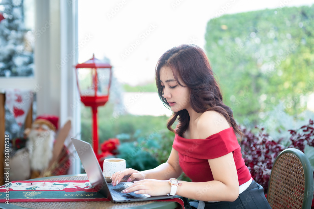 asian freelance people business female talking making using casual working with laptop computer and coffee at home in the living room indoors Decoration During Christmas x-mas and New Year holidays.