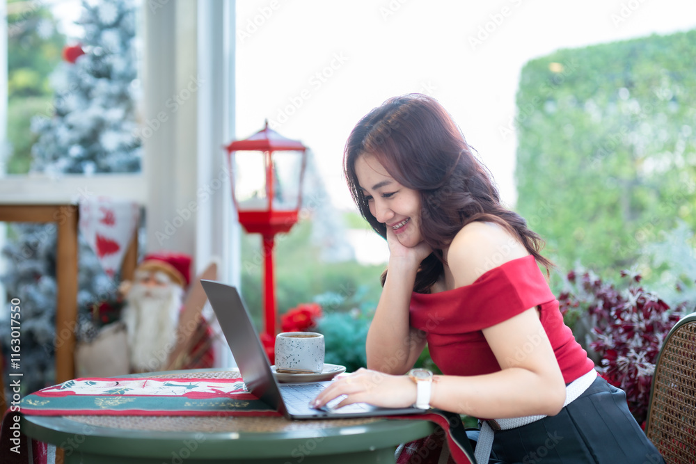asian freelance people business female talking making using casual working with laptop computer and coffee at home in the living room indoors Decoration During Christmas x-mas and New Year holidays.