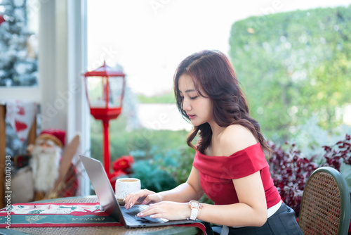 Obraz na płótnie asian freelance people business female talking making using casual working with laptop computer and coffee at home in the living room indoors Decoration During Christmas x-mas and New Year holidays. w salonie