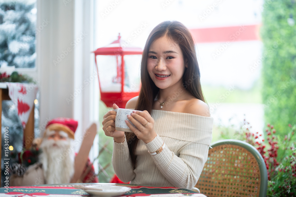 Portrait beautiful asian woman holding of positive the having cup of coffee,milk or chocolate at home in the living room indoors Decoration During Christmas x-mas and New Year holidays.