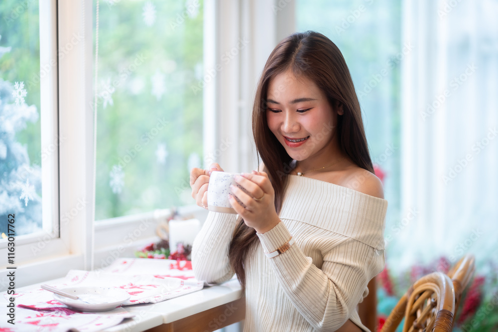 Portrait beautiful asian woman holding of positive the having cup of coffee,milk or chocolate at home in the living room indoors Decoration During Christmas x-mas and New Year holidays.