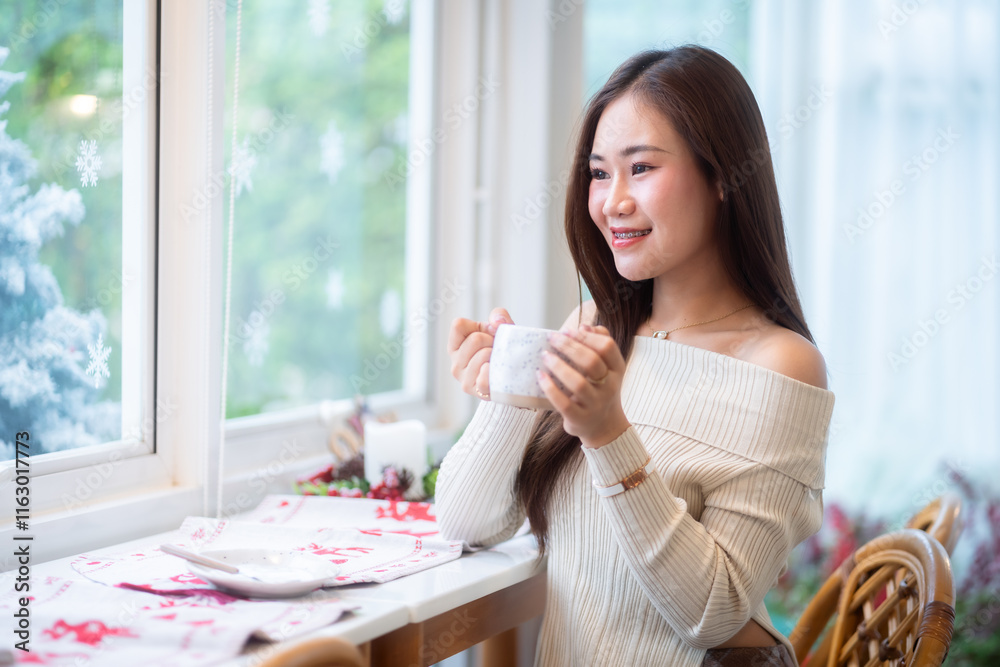 Portrait beautiful asian woman holding of positive the having cup of coffee,milk or chocolate at home in the living room indoors Decoration During Christmas x-mas and New Year holidays.