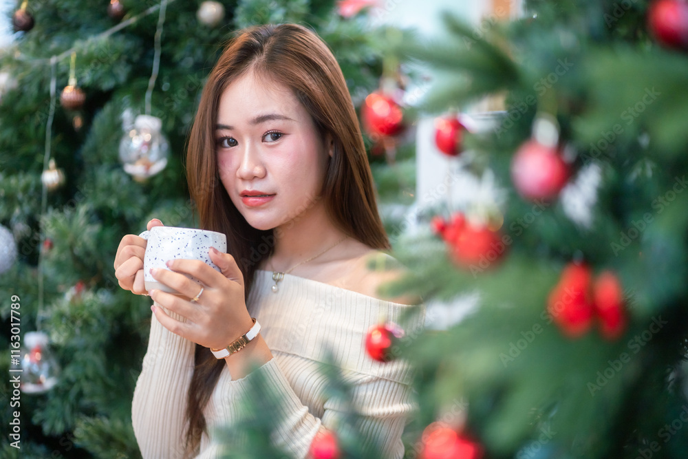 Portrait beautiful asian woman holding of positive the having cup of coffee,milk or chocolate at home in the living room indoors Decoration During Christmas x-mas and New Year holidays.