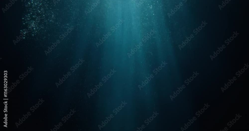 Long high-speed loopable 4K film slow-motion footage of underwater rays piercing ocean surface.  Enchanting beams of light flickering, ideal VFX background for vacation, snorkeling, summer adventures
