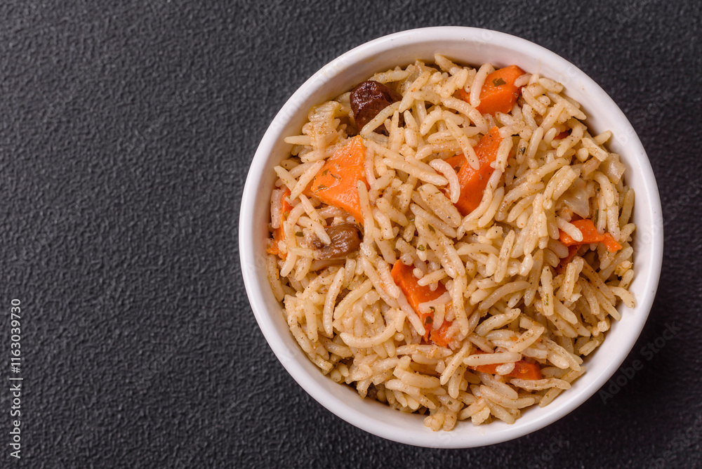 Delicious fresh pilaf with rice, carrots, meat, onions, spices and berries Delicious fresh pilaf with rice, carrots, meat, onions, spices and berries