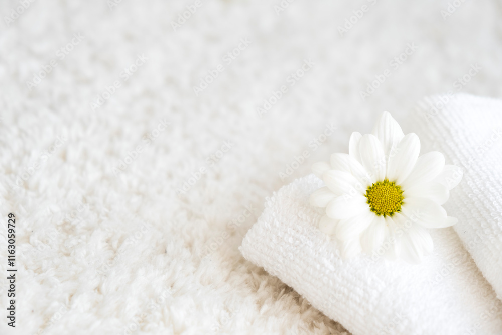 White towels with chamomile flower and aroma lamp, candle on background. Spa and wellness or beauty salon, romantic relaxation concept. Intimate hygiene. Copy space.