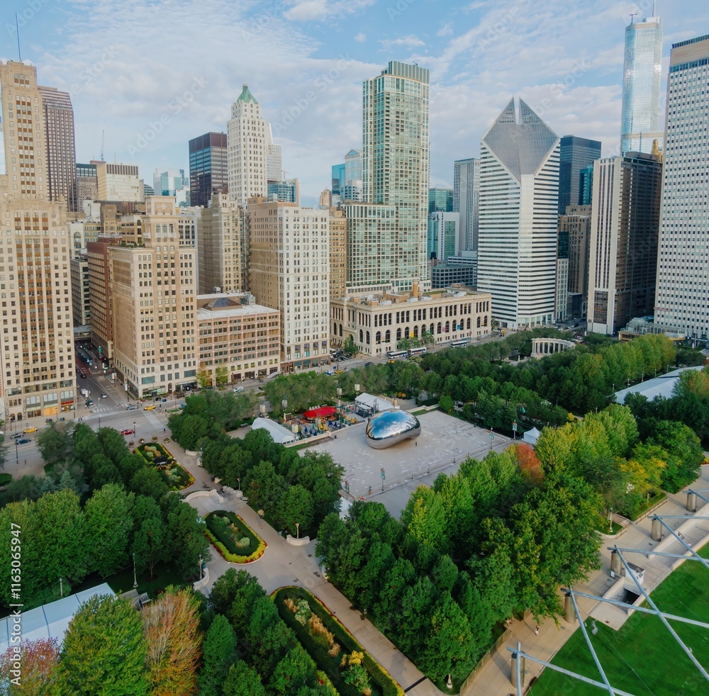Fototapeta premium Chicago skyline and Millennium Park. Cloudless day, people enjoying the park. Iconic Bean sculpture. Millennium Park, Chicago, Illinois, United States