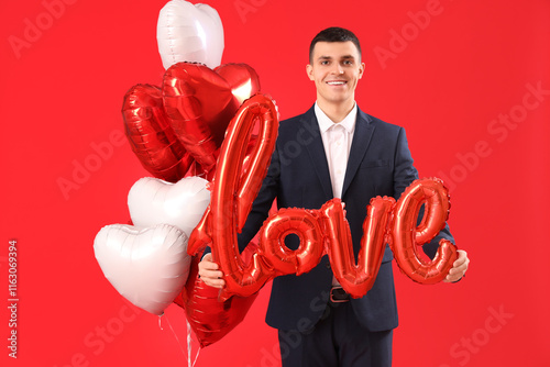 Smiling young man in suit h...