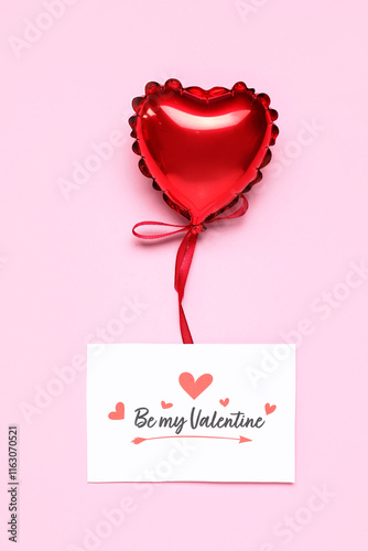 Greeting card with text BE MY VALENTINE and heart-shaped balloon on pink background