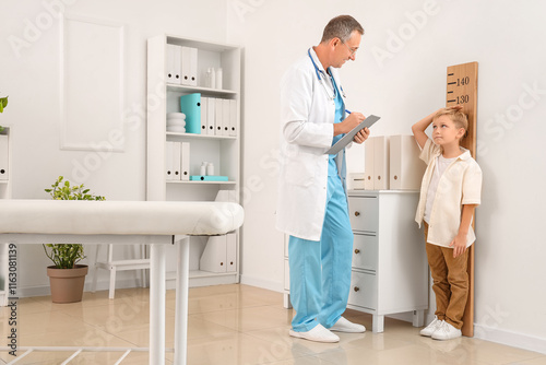 Male pediatrician with litt...