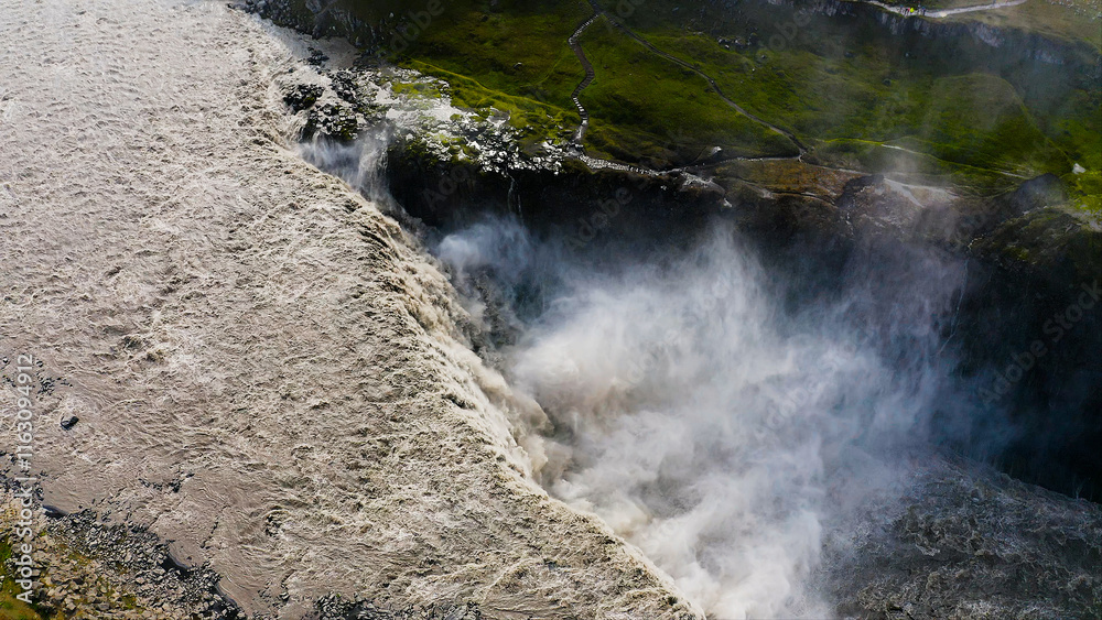 Aerial view of the impressive Dettifoss waterfall, located along the river Jokulsa, falls from a height of 44 metres over a width of 100 metres. Aerial view of the impressive Dettifoss waterfall, located along the river Jokulsa, falls from a height of 44 metres over a width of 100 metres.