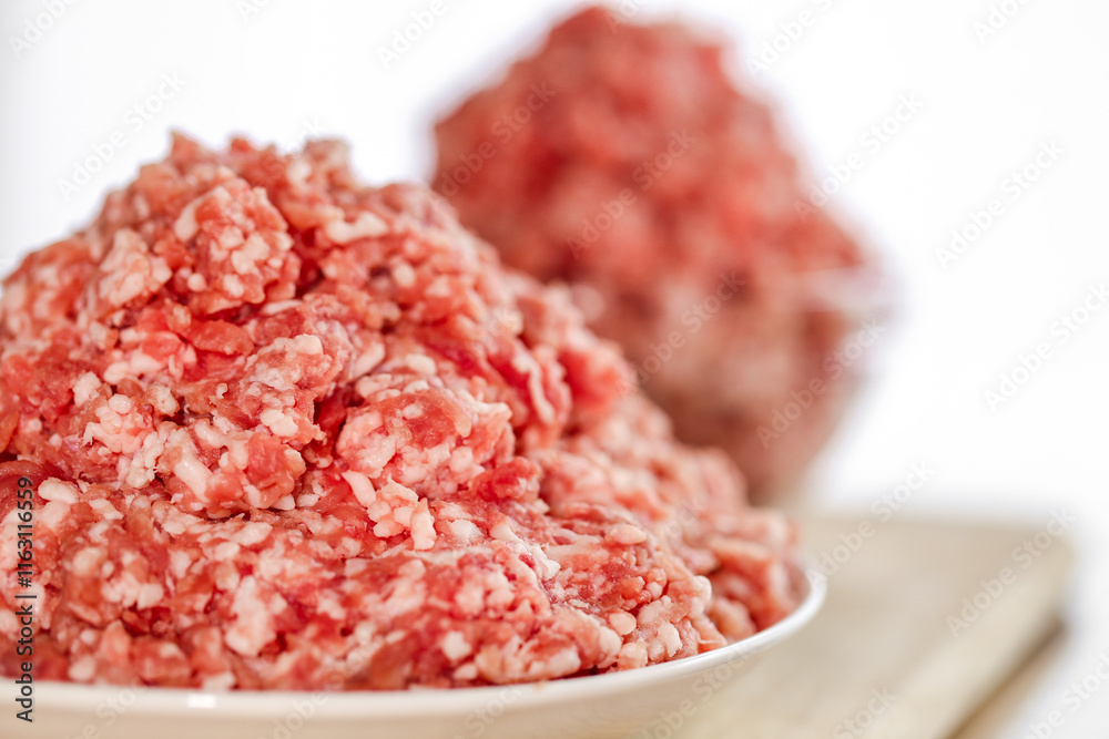 Mince.Ground Meat in a glass cup on a white background. Fresh meat bio product.Close-Up of Ground Meat in a Bowl.Fresh Ground Meat Mince.Ground Meat in a glass cup on a white background. Fresh meat bio product.Close-Up of Ground Meat in a Bowl.Fresh Ground Meat