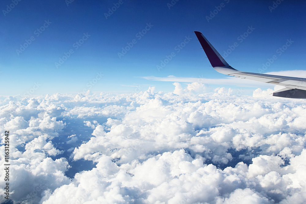 Obraz premium Beautiful Cloudy Sky with Clouds from Airplane Window and Plane Wing