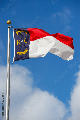 North Carolina state flag waving on the pole in the wind photo