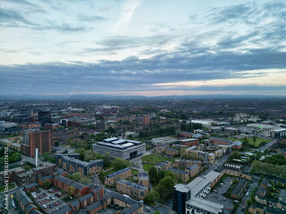 Naklejka premium Aerial View of Buildings at Greater Manchester Central City, Northwest of England, United Kingdom. Aerial View Footage Was Captured with Drone's Camera on May 4th, 2024 During Sunset Time.