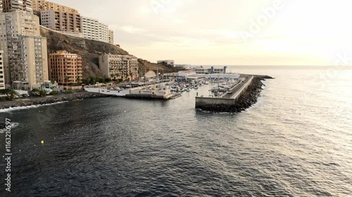 Drone of Puerto Deportivo Radazul marina at sunset - boats docked in calm waters photo