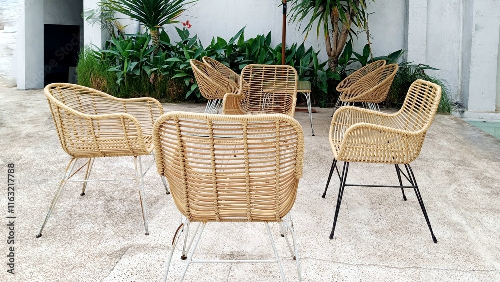Classic Furniture Rattan Chairs and Table combined with glass and wooden rattan on the front terrace of the house Classic Furniture Rattan Chairs and Table combined with glass and wooden rattan on the front terrace of the house