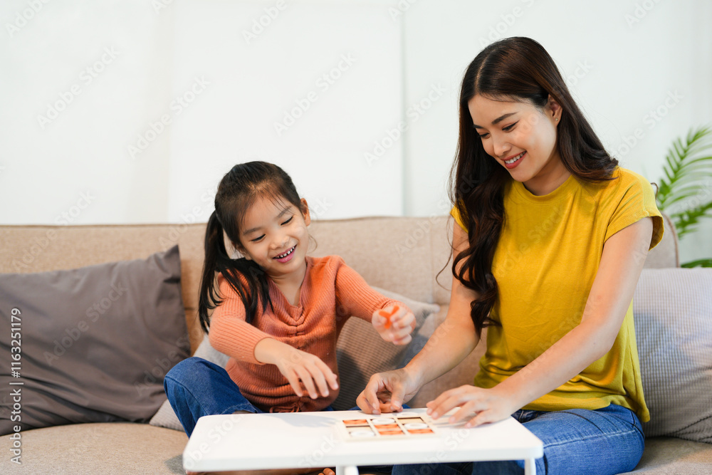Asian beautiful loving mom playing game with daughter in house. Attractive woman parent spend free leisure time with young little girl child spend time learn and develop skill with kid's toy. Asian beautiful loving mom playing game with daughter in house. Attractive woman parent spend free leisure time with young little girl child spend time learn and develop skill with kid's toy.