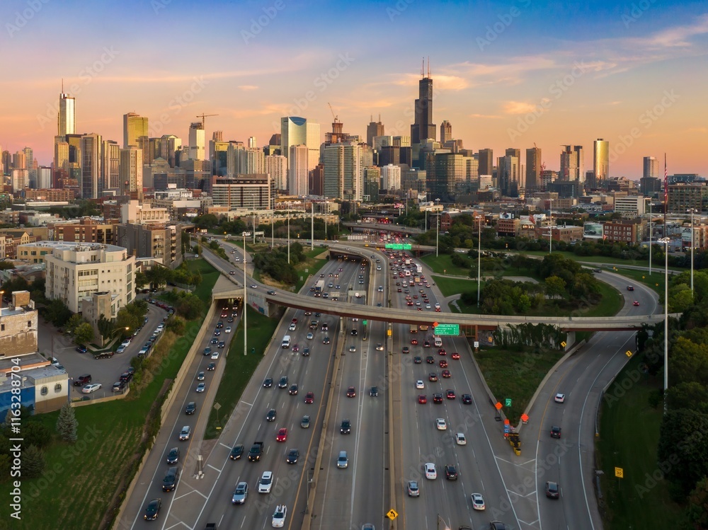 Fototapeta premium Chicago's highway system at sunset, showing heavy traffic flow and city skyline. Vehicles navigate the complex highway network. Interstate 90, Chicago, Illinois, United States