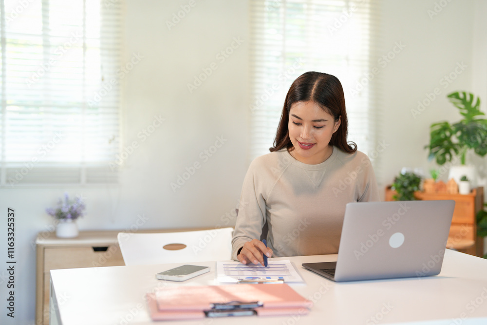 Asian Businesswoman Using laptop computer and working at office with calculator document on desk, doing planning analyzing the financial report, business plan investment, finance analysis concept. Asian Businesswoman Using laptop computer and working at office with calculator document on desk, doing planning analyzing the financial report, business plan investment, finance analysis concept.