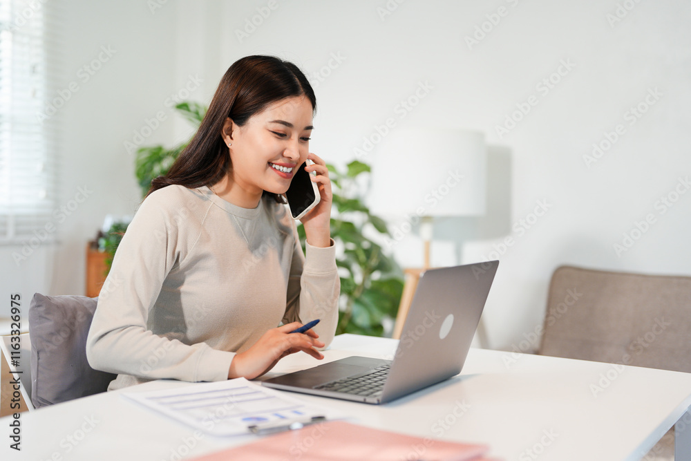 Happy young Asian business woman with a smile using smartphone at the office. Happy young Asian business woman with a smile using smartphone at the office.