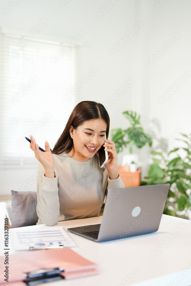 Happy young Asian business woman with a smile using smartphone at the office. Happy young Asian business woman with a smile using smartphone at the office.