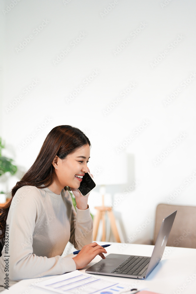 Happy young Asian business woman with a smile using smartphone at the office. Happy young Asian business woman with a smile using smartphone at the office.