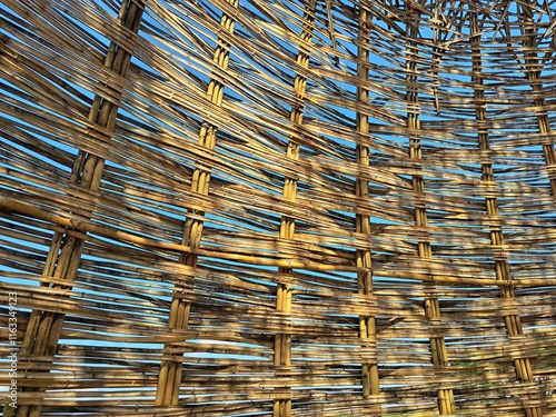 The bamboo floor is tightly woven with sunlight casting partial shadows on the bamboo surface. Woven bamboo floor photo