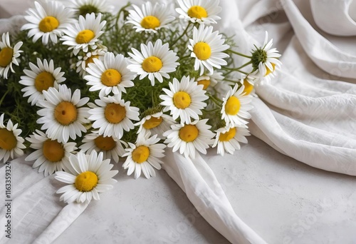 A bouquet of chamomile flowers on a draped background