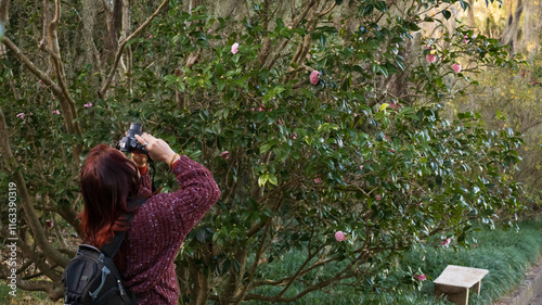 lady taking pictures in a park